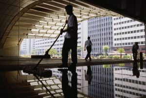 Progressive's quality assurance program ensures that all healthcare cleaning services are inspected weekly. A man cleans the lobby floor of an executive office building.