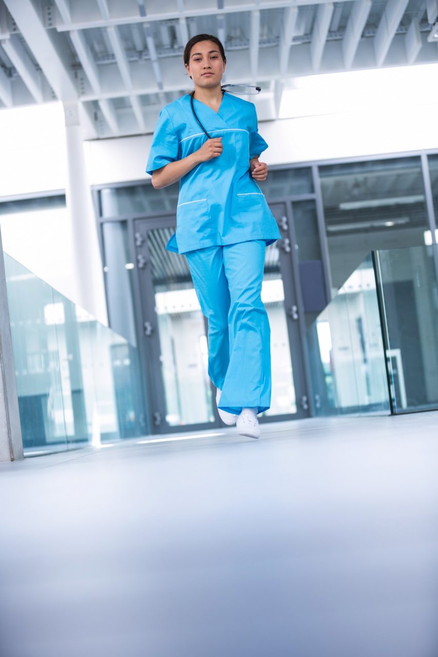 Nurse running in hospital corridor.