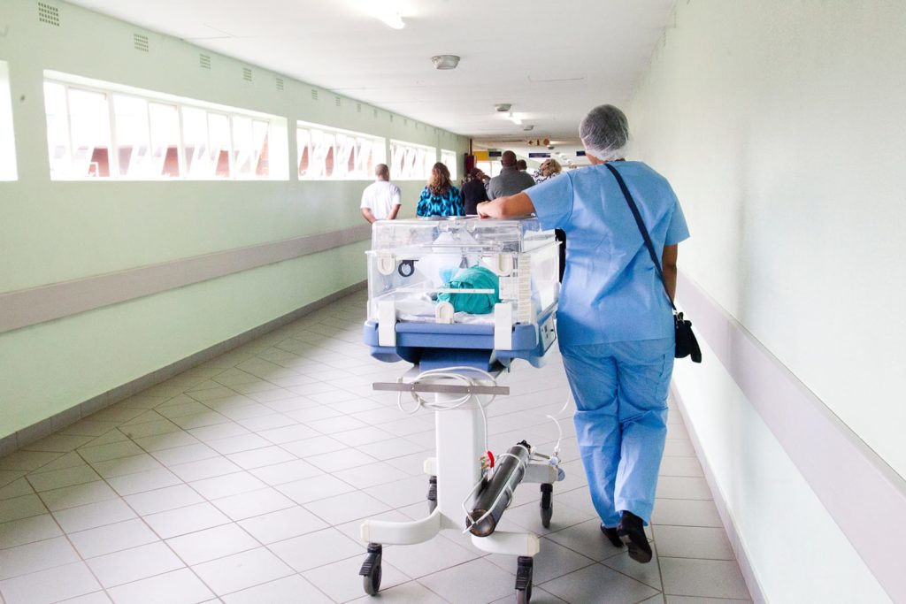 Poor hospital cleanliness affects everybody, especially newborns struggling during early stages of development. A nurse walks a baby to the NICU ward.